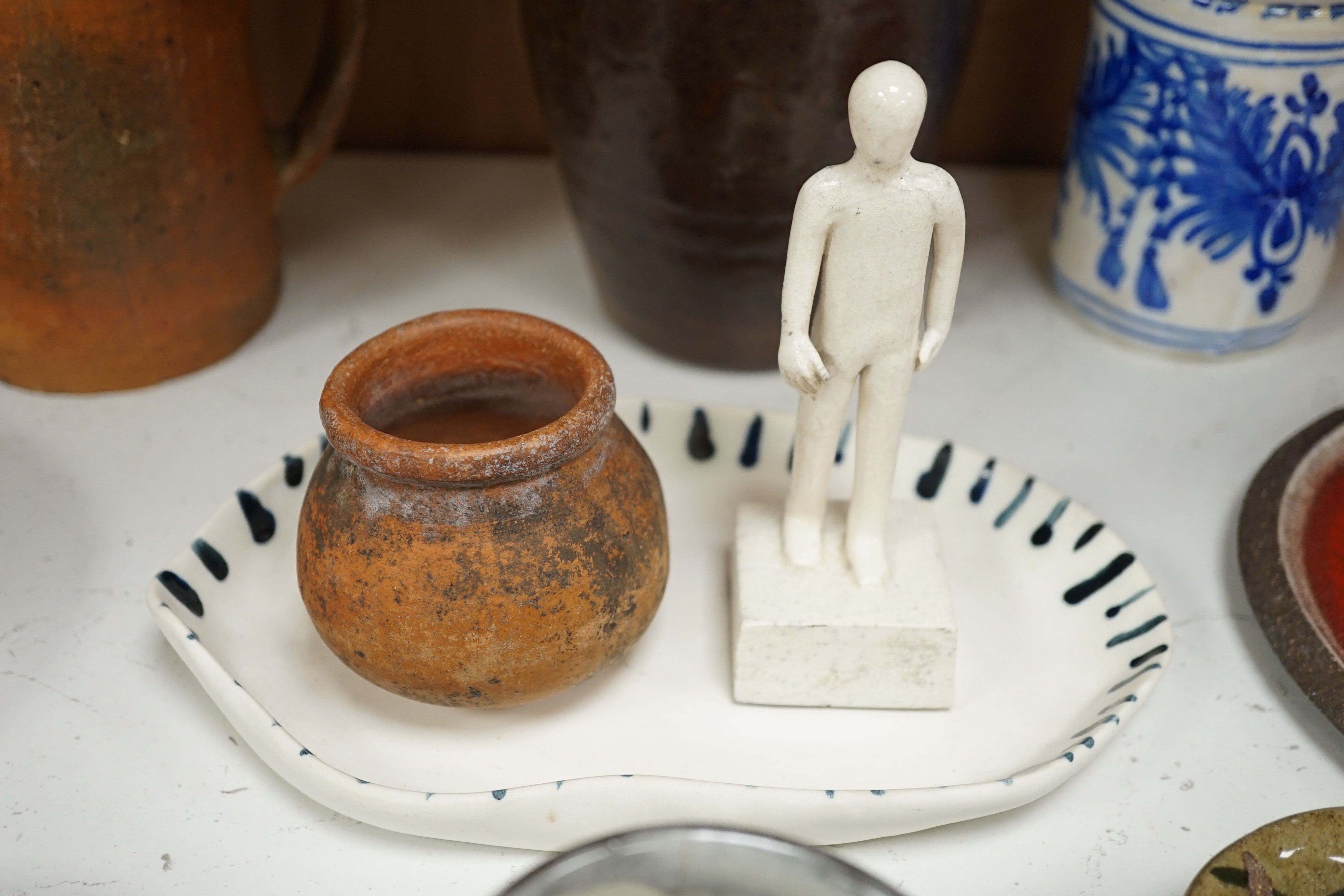 A group of studio pottery including St. Ives Leach pottery jug two dishes and a saucer